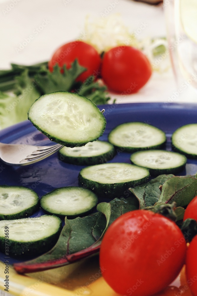 Dietary food background: vegetable salad with cherry tomatoes and cucumbers, vegan cuisine