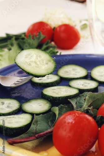 Obraz na płótnie Dietary food background: vegetable salad with cherry tomatoes and cucumbers, vegan cuisine w salonie