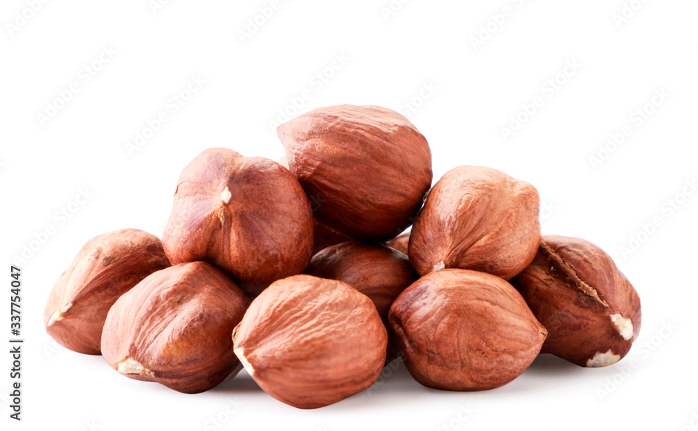 A pile of hazelnuts closeup on white background. Isolated A pile of hazelnuts closeup on white background. Isolated