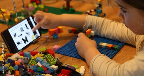 Little girl online learning and creating at home. Quarantine and Social distancing concept.