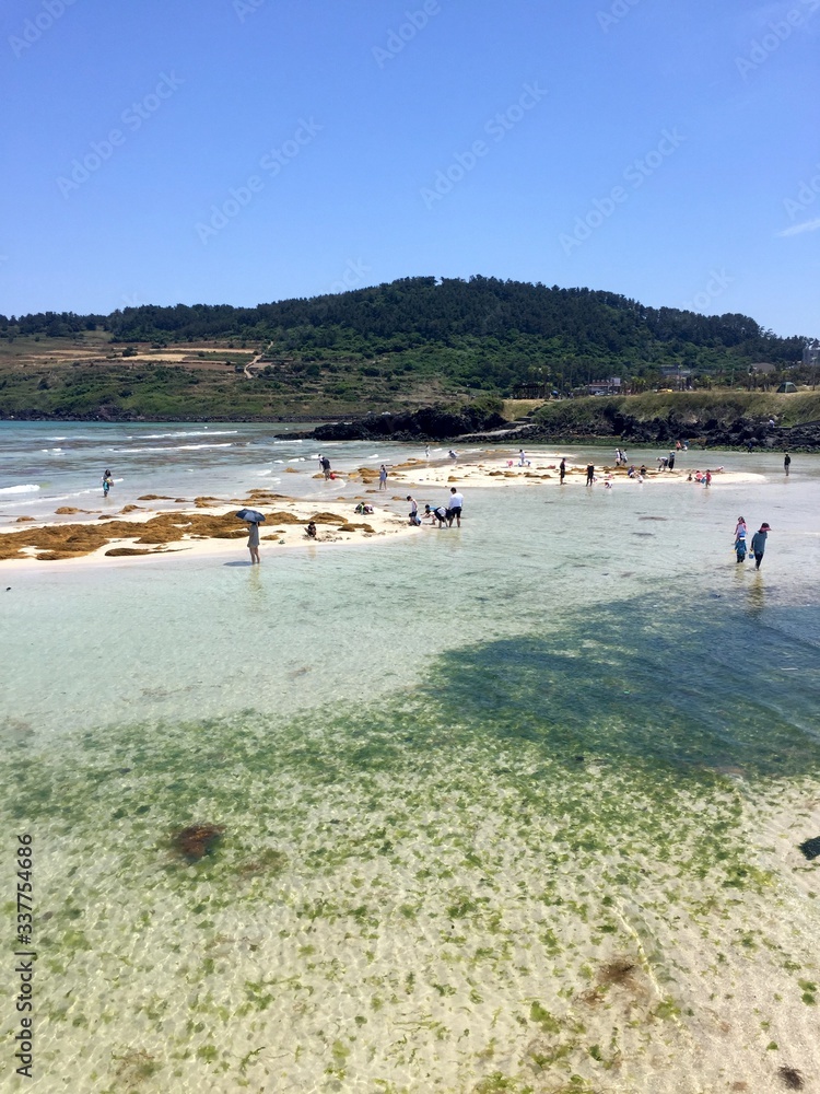 Jeju, South Korea - 14th March 2017: Scenery of Hamdeok Beach and emerald seashore in Jochon-eup, Jeju-si, Jeju-do, South Korea Jeju, South Korea - 14th March 2017: Scenery of Hamdeok Beach and emerald seashore in Jochon-eup, Jeju-si, Jeju-do, South Korea