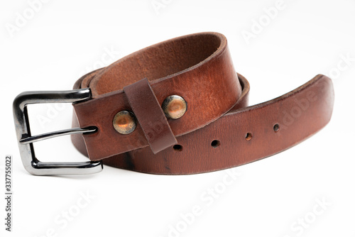 A formal studio product shot of a men’s used brown leather belt with patina set on plain white background.