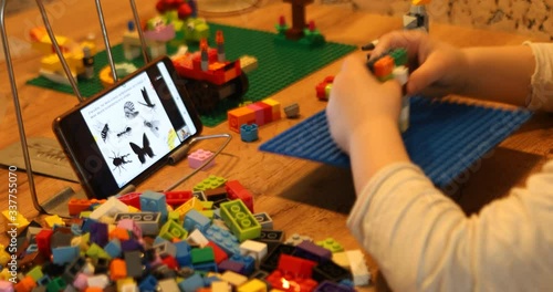 Little girl online learning and creating at home. Quarantine and Social distancing concept.