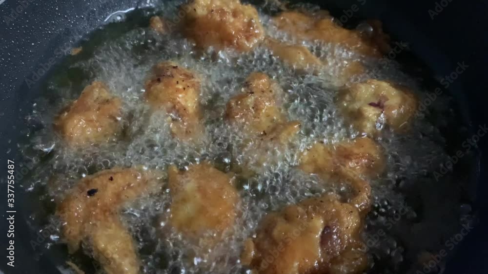 Chicken wings and chicken wings covered in batter in boiling oil Chicken wings and chicken wings covered in batter in boiling oil