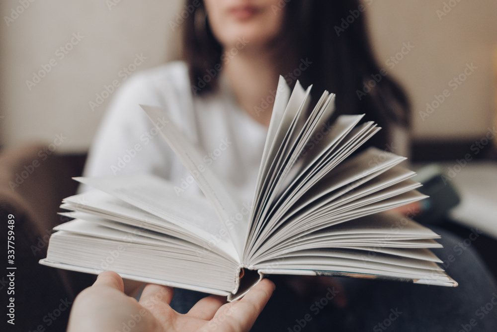 open book in front of a girl, paper pages open book in front of a girl, paper pages