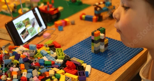 Little girl online learning and creating at home. Quarantine and Social distancing concept.