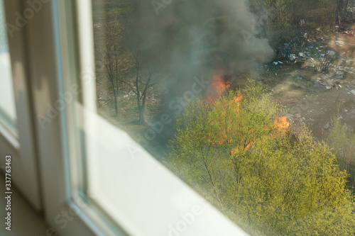 Wildfire near houses  view from the apartment window