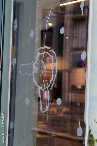 Broken window glass of a store located in downtown Zürich, Switzerland. Crushed and shattered glass, hopefully the insurance will cover the damage. Concept of stealing, criminal activity and security. © Nora