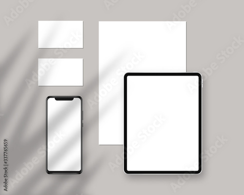 Vector stationery mockup with tablet, paper, business cards, smartphone. Stationery mockup with shadow overlays. Branding stationery mockup scene. Corporate identity design.