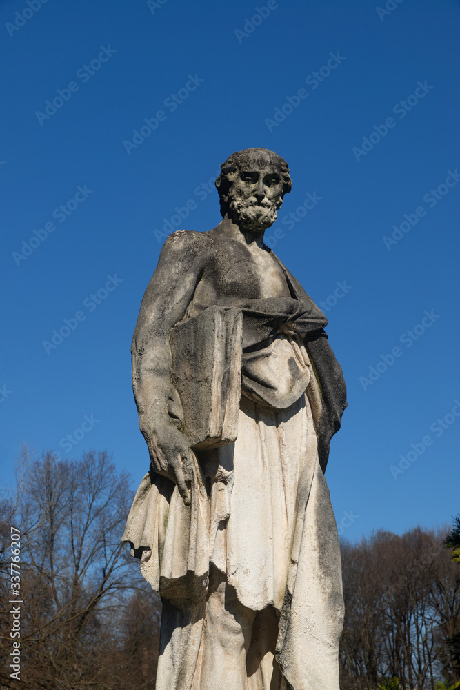 Soft stone statue exposed at Parco Querini, the largest public park in the city of Vicenza. The sculpture probably represents a philosopher from classical Greece and was made between 1600 and 1700