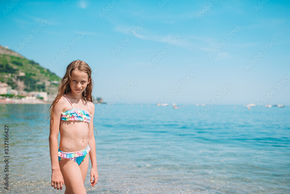 Cute little girl at beach during summer vacation Cute little girl at beach during summer vacation