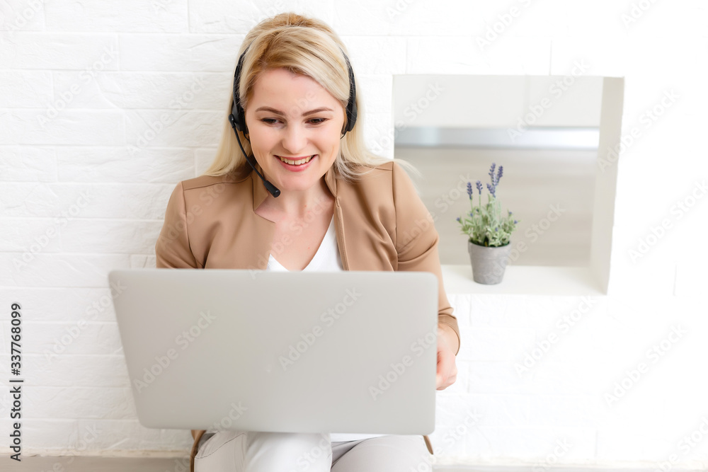 Portrait of happy skilled middle aged woman life coach, business consultant, psychologist or medical advisor smiling joyfully at camera, working on laptop, enjoying her job, helping people online Portrait of happy skilled middle aged woman life coach, business consultant, psychologist or medical advisor smiling joyfully at camera, working on laptop, enjoying her job, helping people online