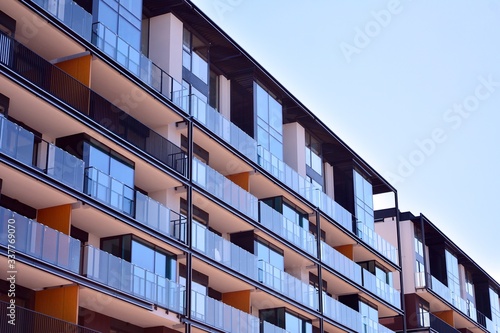 Modern and new apartment building on a sunny day with a blue sky. Contemporary residential building exterior in the daylight.
