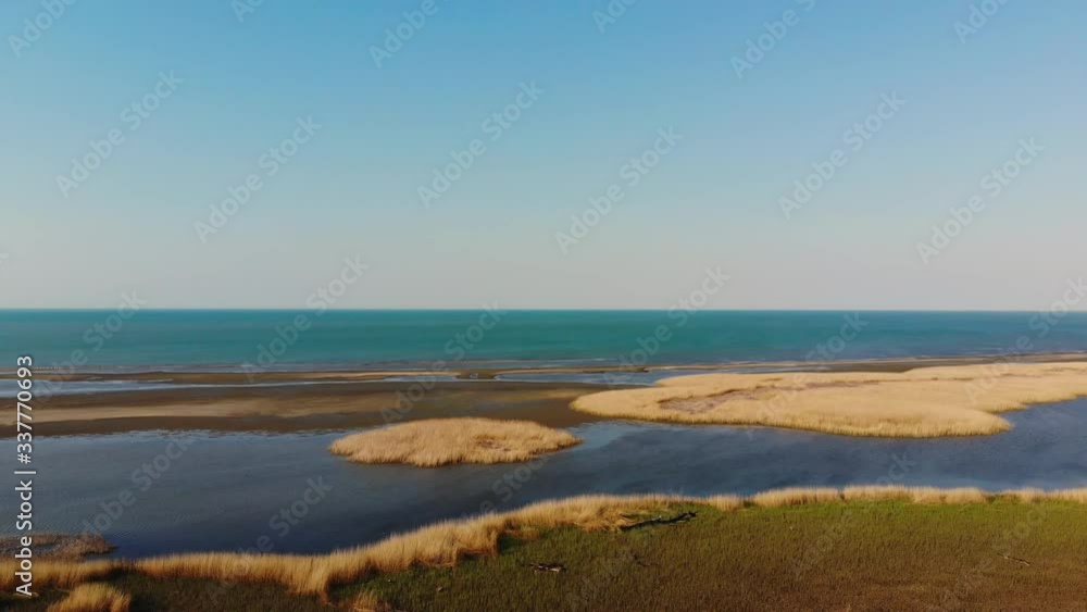 Beautiful sunset on the beach. Orange sunrise at the sea. Beautiful landscape with the rising sun over the sea. 4k frames. Real time Russia, Sea of Azov. Pretty calm morning waves. Beautiful sunset on the beach. Orange sunrise at the sea. Beautiful landscape with the rising sun over the sea. 4k frames. Real time Russia, Sea of Azov. Pretty calm morning waves.
