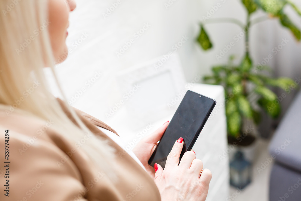 Portrait of beautiful young woman using her mobile phone at home. Portrait of beautiful young woman using her mobile phone at home.