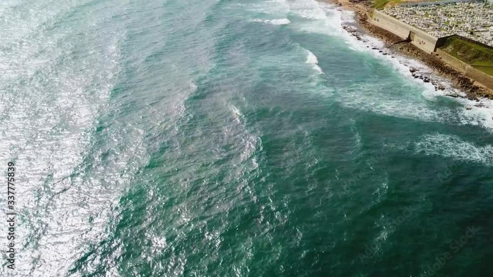 Aerial, tilt up, drone shot over the sea, revealing colorful buildings, at the La Perla area, in San Juan, Puerto Rico, USA Aerial, tilt up, drone shot over the sea, revealing colorful buildings, at the La Perla area, in San Juan, Puerto Rico, USA