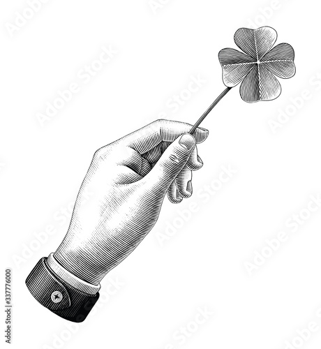 Hand hold clover leaf drawing vintage style black and white clipart isolated on white background