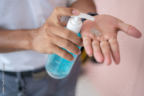 Men wash their hands with gel  alcohol or soap to kill bacteria after using public toilets. Prevents the spread of germs and bacteria and avoids corona virus infection.