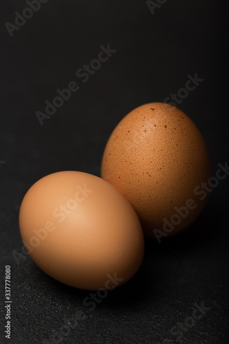 Eggs on black background,  selective focus, close up, deep shadows

