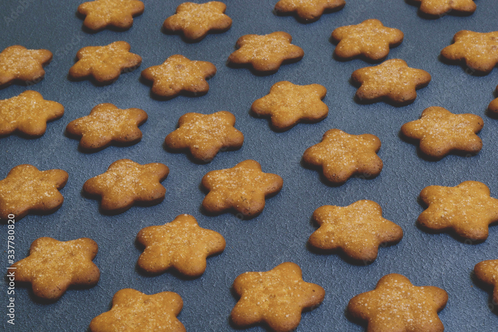 Cookies in the shape of stars on dark background. A place for your information. Cookies close up. Copy space. Selective focus. Cookies in the shape of stars on dark background. A place for your information. Cookies close up. Copy space. Selective focus.