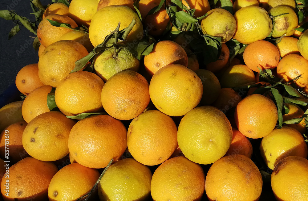 Ripe oranges on the Greek market stacked in a pyramid