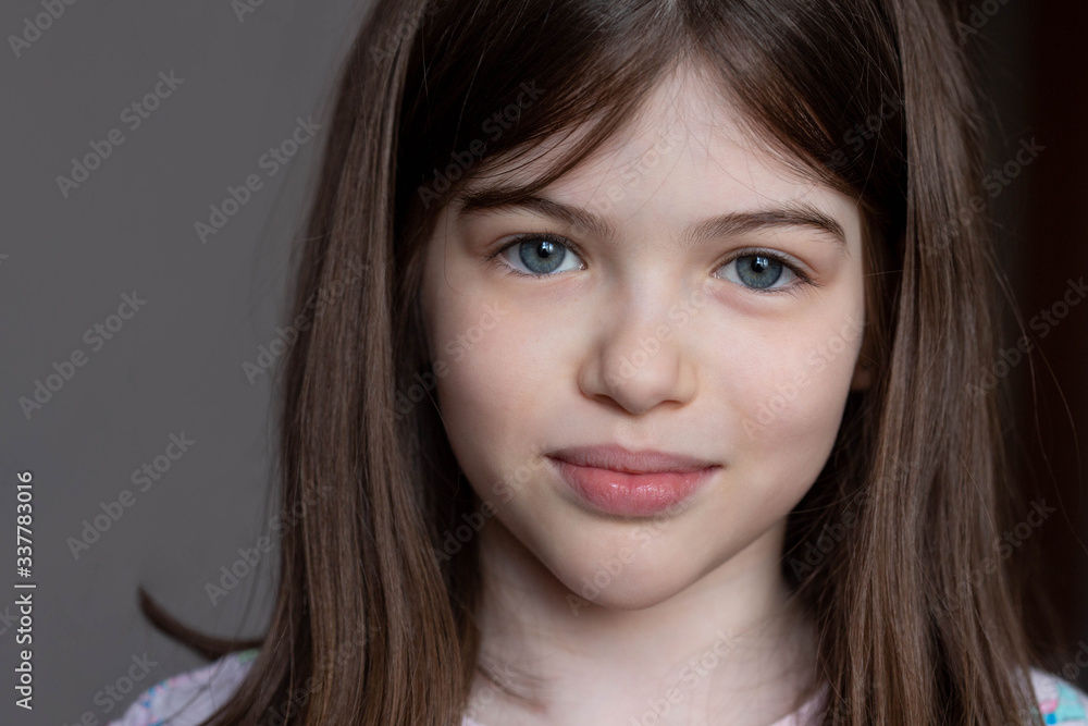 close-up portrait of a young beautiful brunette girl with big blue eyes close-up portrait of a young beautiful brunette girl with big blue eyes