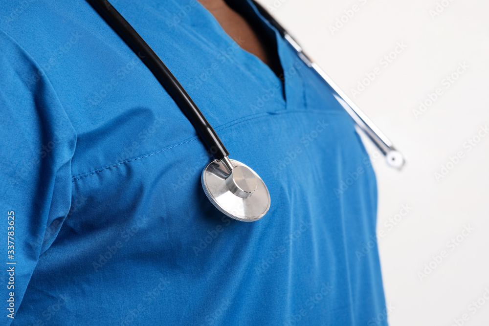 Stethoscope on black doctor chest, close up Stethoscope on black doctor chest, close up