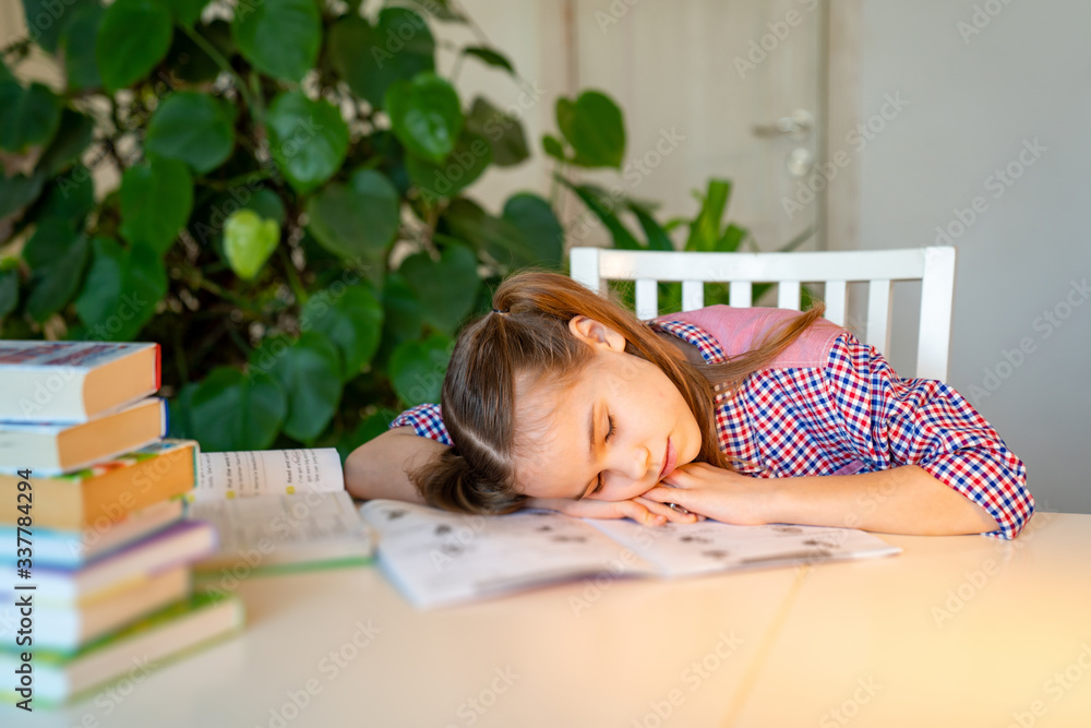 sleepy schoolgirl doing homework. studying at home sleepy schoolgirl doing homework. studying at home