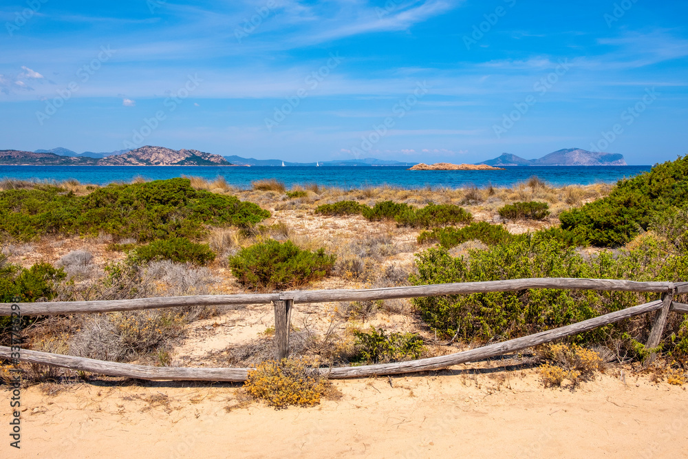 Panoramic view of Spalmatore di Terra peninsula of Marine Protected Area natural reserve with Mediterranean scrub of Isola Tavolara island on Tyrrhenian Sea off northern coast of Sardinia, Italy