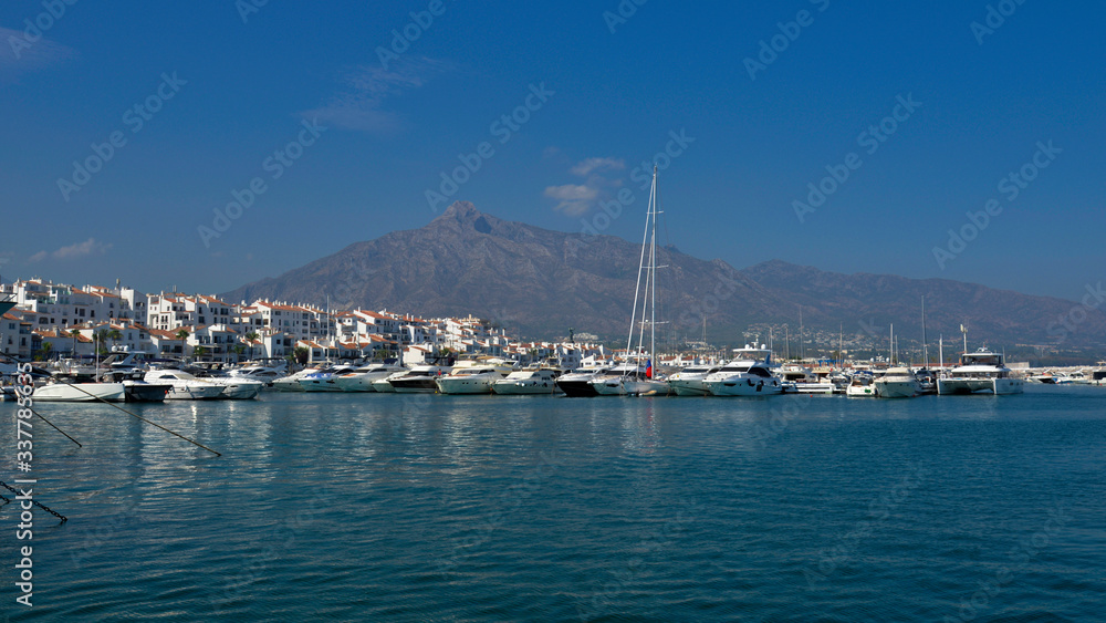White yachts in the bay against the background of white houses and mountains