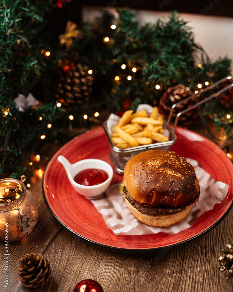 top view of beef burger served with french fries ketchup ear christmas decorations top view of beef burger served with french fries ketchup ear christmas decorations