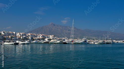 White yachts in the bay against the background of white houses and mountains