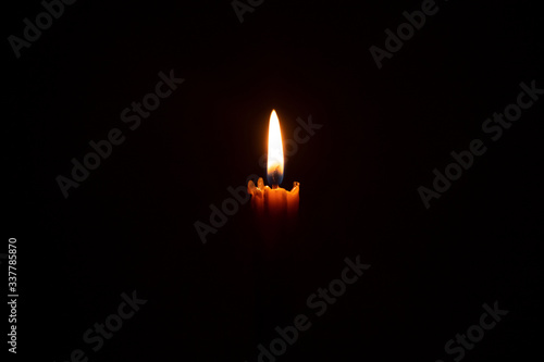 a wax candle glowing in the dark