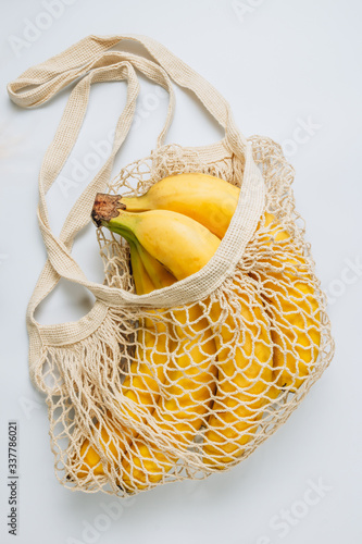 Eco cotton string mesh bag with Bananas. Ecological Zero Waste Food Shopping concept. Top view. Flat lay Top view. Flat lay