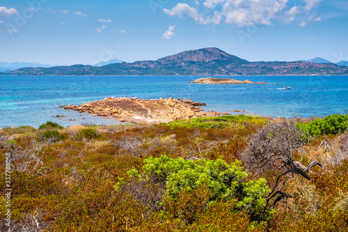 Panoramic view of Spalmatore di Terra peninsula of Marine Protected Area natural reserve with seashore rocks of Isola Tavolara island on Tyrrhenian Sea off northern coast of Sardinia, Italy photo