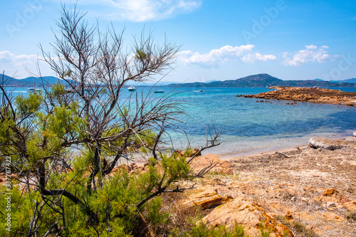 Panoramic view of Spalmatore di Terra peninsula of Marine Protected Area natural reserve with Mediterranean scrub of Isola Tavolara island on Tyrrhenian Sea off northern coast of Sardinia, Italy photo