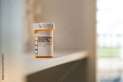 Hydroxychloroquine (Chloroquine) Pills, prescription bottle for possible (Unproven) Treatment To COVID-19. Generic drug for Plaquenil On white Background photo