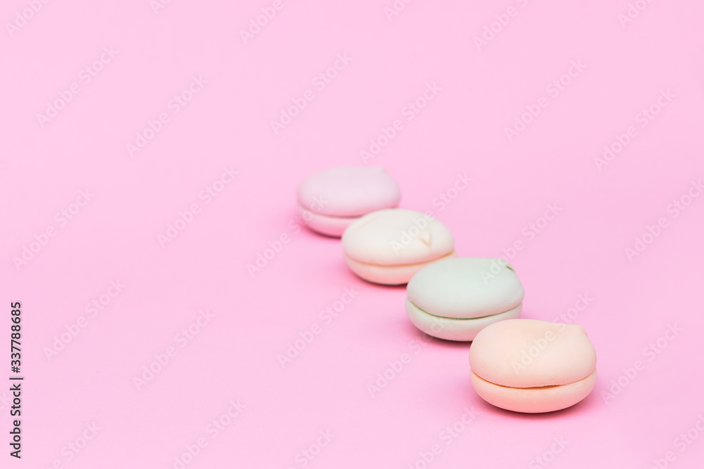 Delicate colored marshmallows on a pink background minimal style. Copy space Delicate colored marshmallows on a pink background minimal style. Copy space