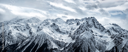 Panoramic view of snowy Caucasus mountain ridge in Karachayevo-Circassian Republic, Russia
