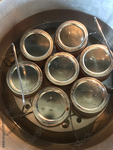 canning jars in stainless steel pressure cooker water bath