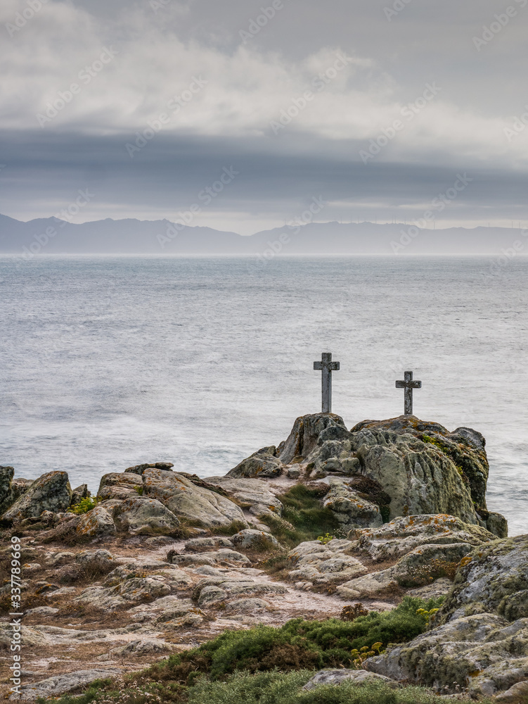 Two crosses on a rock at Cape Roncudo in La Coruña, Galicia, Spain.