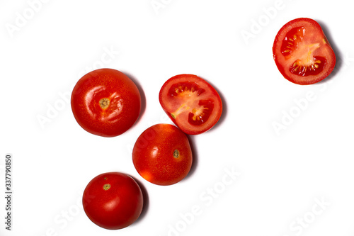 Tomatoes on white background. Slices of red tomatoes being prepared for food. Space for text