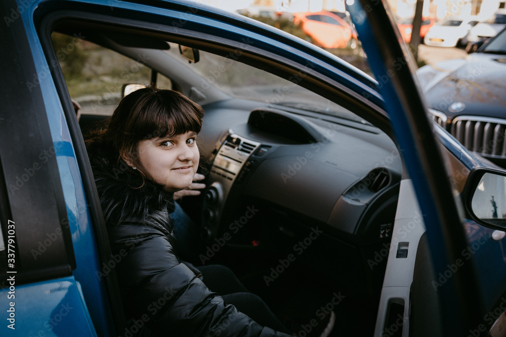 Caucasian girl sitting in blue auto, travel Caucasian girl sitting in blue auto, travel