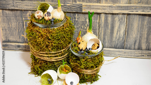 Easter decoration with natural moss, onions and eggs on a gray antique background. Decor.