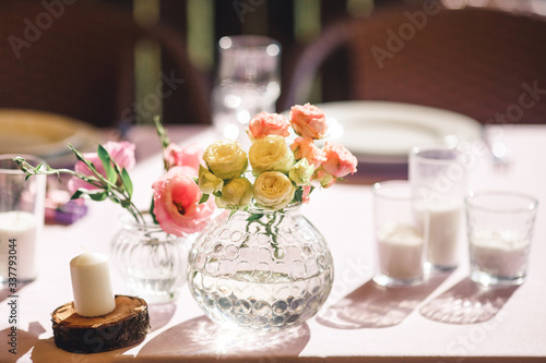 restaurant festive table decor with flowers and candles