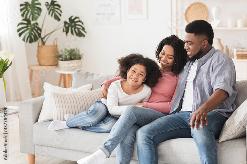 Modern Black Family With Little Daughter Spending Time At Home Together