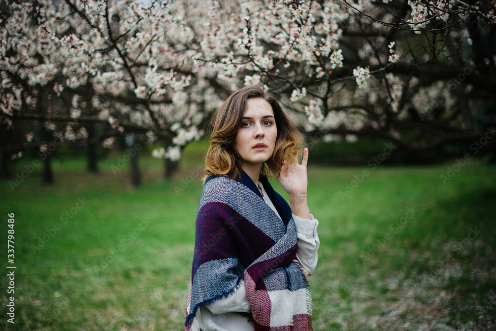 Beautiful young girl is resting and enjoying spring in the spring park Beautiful young girl is resting and enjoying spring in the spring park