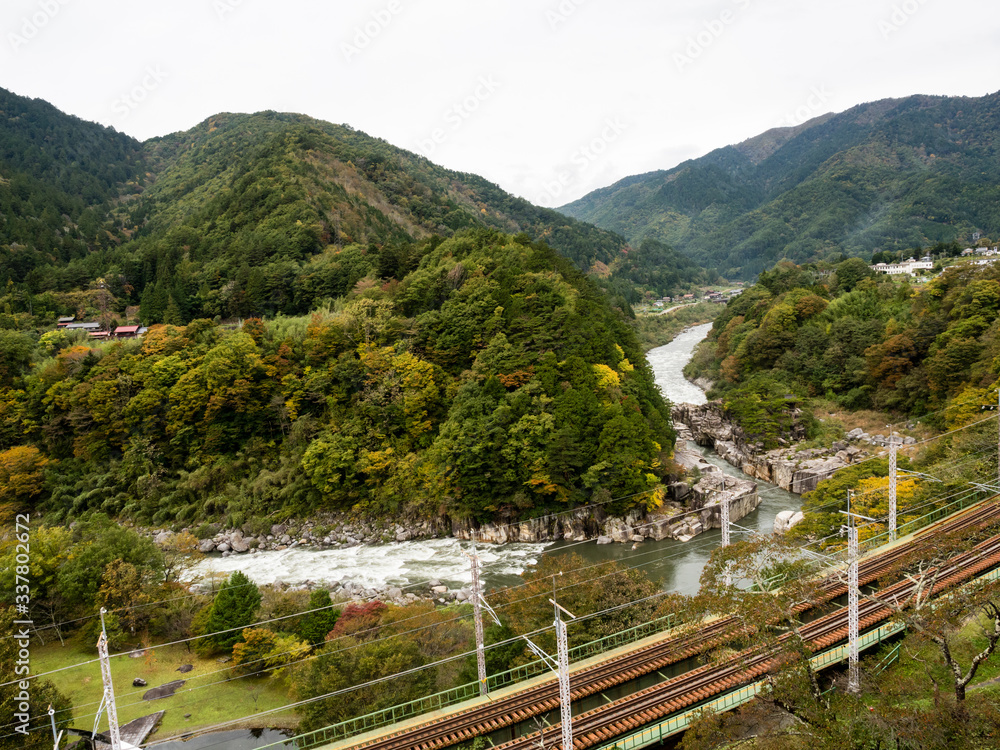Chuo Main Line running through the scenic Kiso Valley at Nezame-no-Toko Gorge - Nagano prefecture, Japan