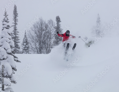 Freerider is buried in fresh snow, turning and jumping between the trees. freeride skiing in deep powder snow. Chest deep snow during snow storm. Good powder day. Funny skiing, rides over off-piste