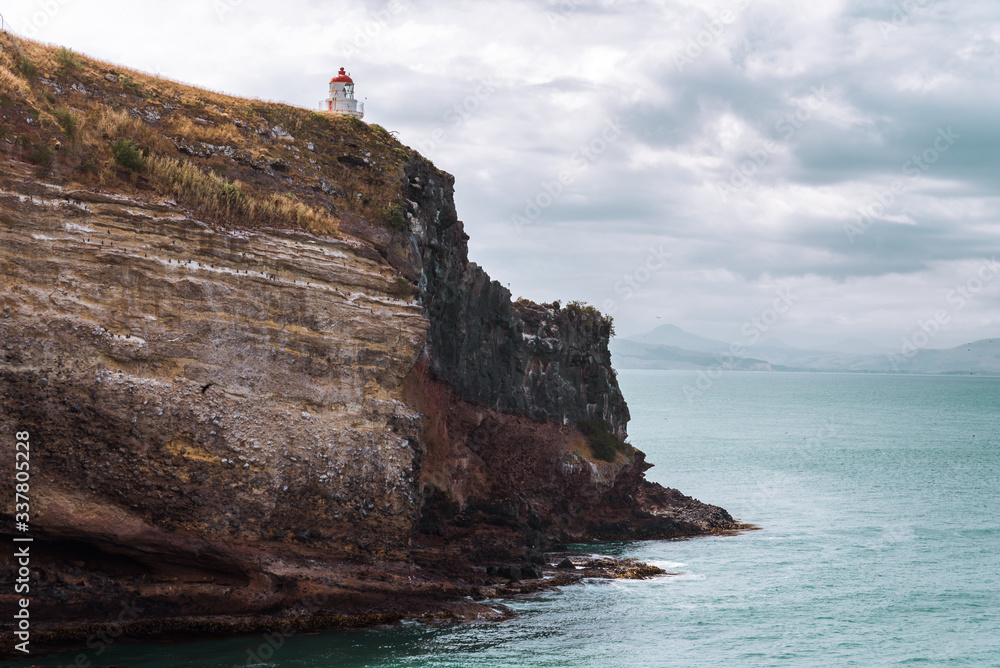 Lighthouse on cliffs with seascape Lighthouse on cliffs with seascape